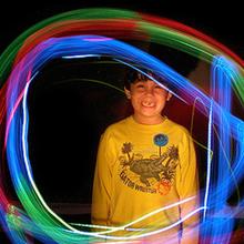 Boy circled by neon lights