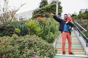 Father holding baby on steps in San Francisco